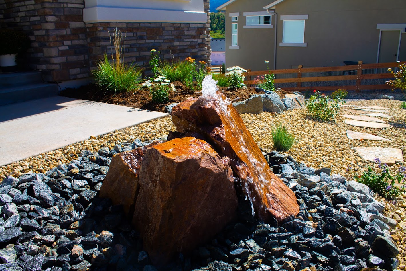 bubbling boulder xeriscaping flagstone walkway shrub grasses perennials Colorado landscaping